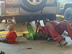 Fuel pump on a Jeep Liberty and that's my little nephew training to be a mechanic just like his daddy and his uncle